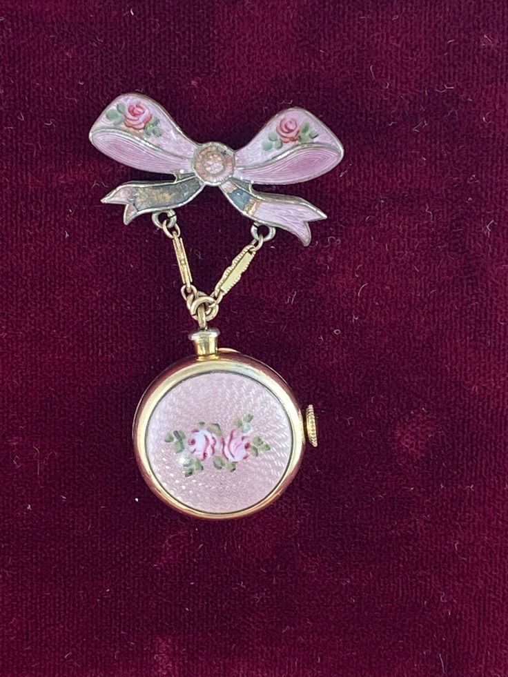 Vintage Harman Broach WW2 Boy Friend Pin with Bow Ribbon Watch  hand made Pink Guilloche Enamel with 2 Roses Pin Bow also with small rose buds Brooch Pin 1.25 inches wide 2 inches tall inch Bow and watch is 7/8 inch in diameter. This is Hand made from the 40's Harman 7 Jewel Movement Manual watch in a Bronze 12K Karat Gold plated  known as a boy friend pin during WW2 Vintage Harman Watch Not working hand made Guilloche Enamel with Pink Roses Balance ticks for a few seconds, balance does turn fre Ribbon Pin, Guilloche Enamel, Pink Aura, Bow Ribbon, Neck Jewellery, Small Rose, Jewelry Lookbook, Girly Jewelry, Fashion Design Clothes