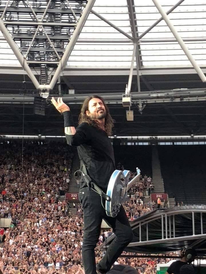 a man standing on top of a stage in front of a crowd