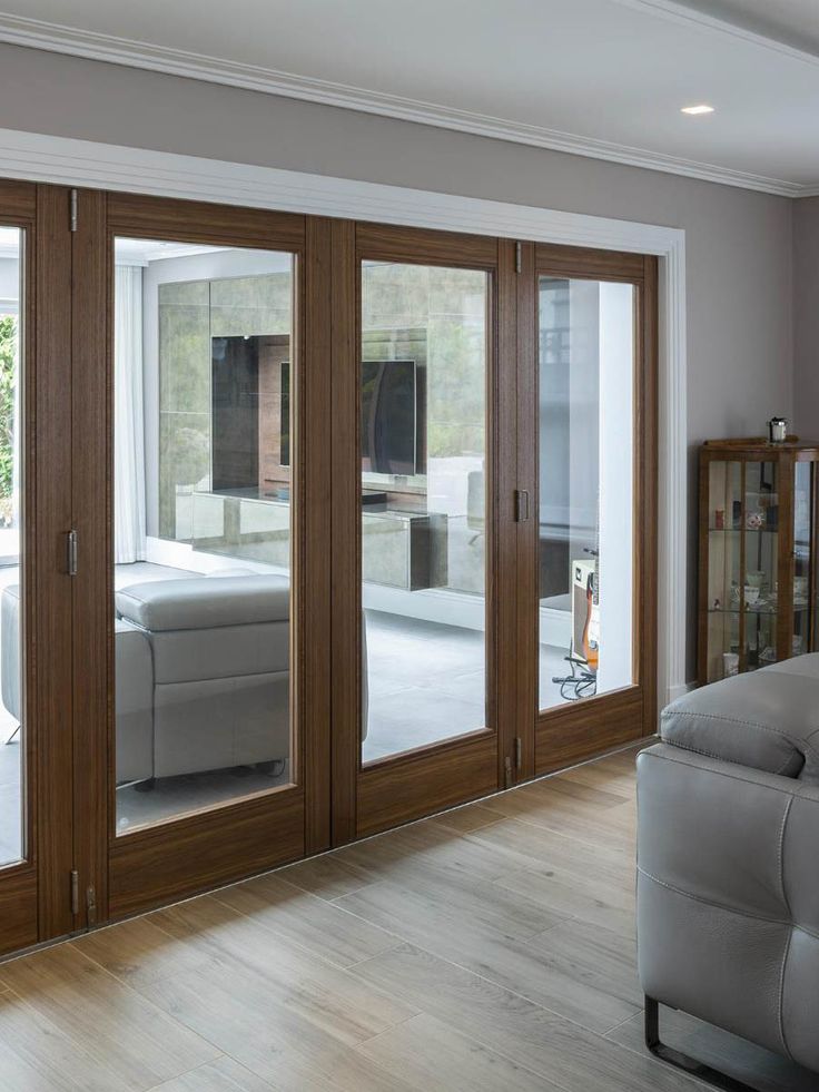 a living room filled with furniture and sliding glass doors