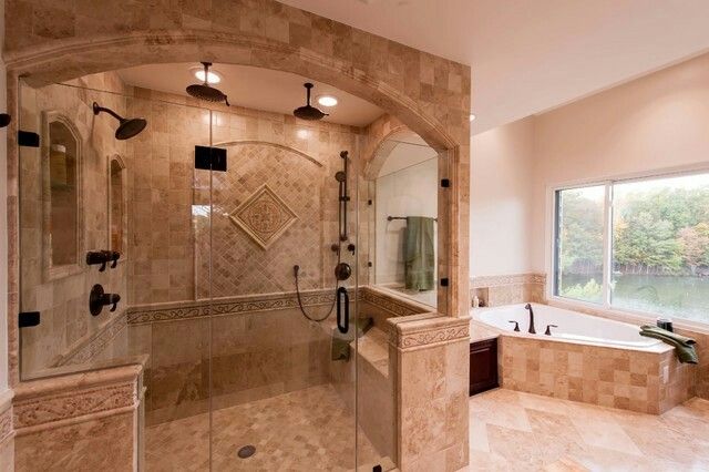 a large bathroom with a walk in shower next to a bathtub