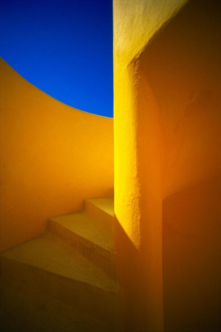 an orange wall and stairs with blue sky in the background