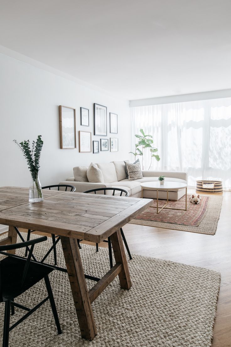 a living room filled with furniture and a wooden table