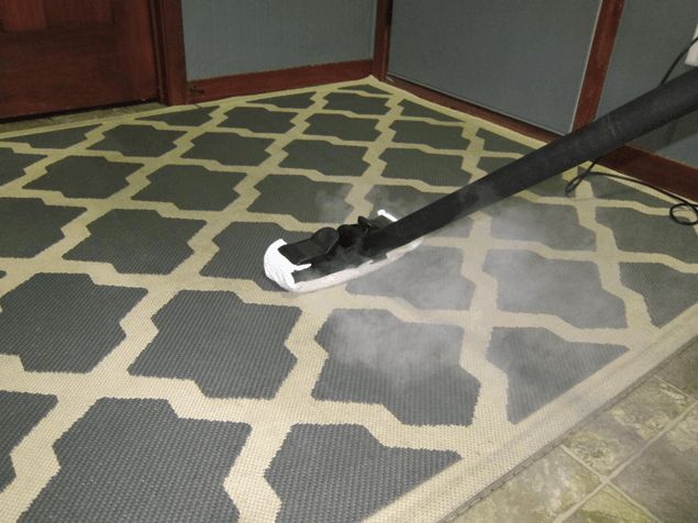 a black and white umbrella on the floor with steam coming from it's handle