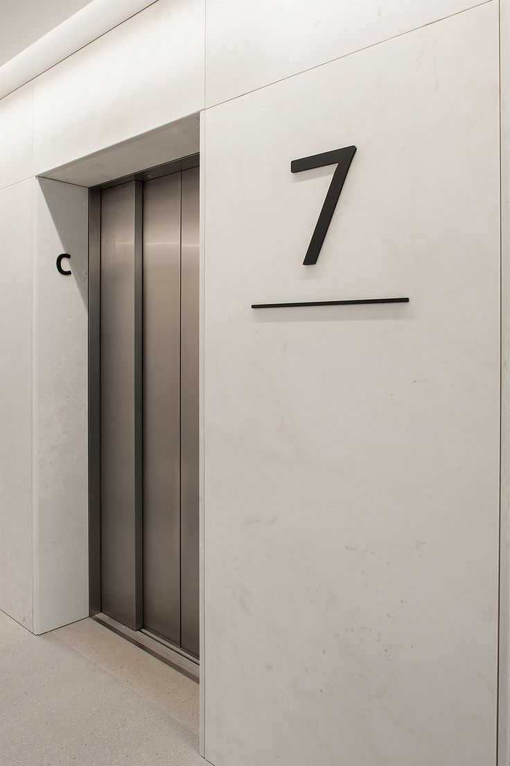 an elevator with the number seven on it's wall and doors open to let people know where they are going