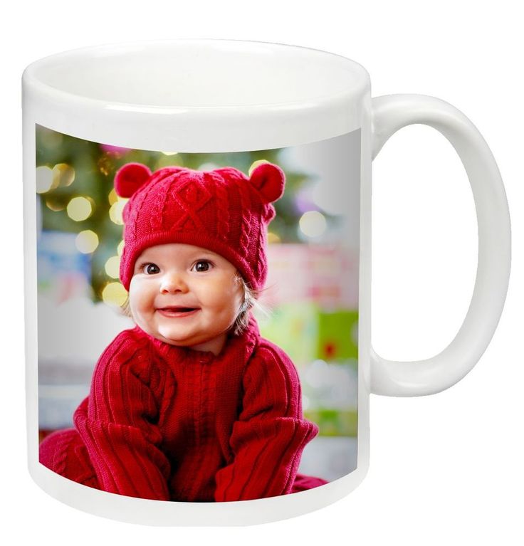 a white coffee mug with an image of a baby wearing a red sweater and hat