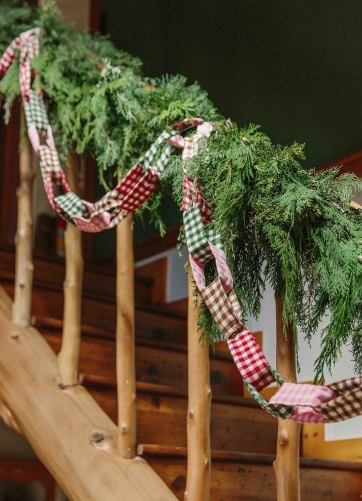 christmas garlands are tied on the banister