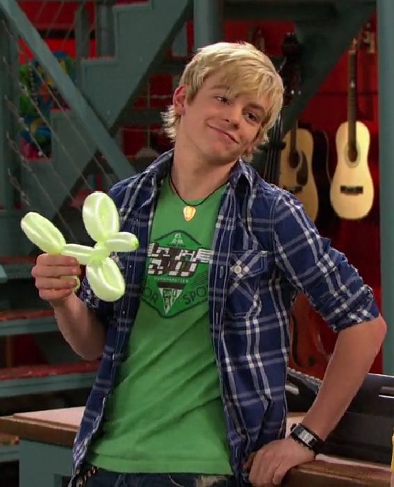 a young man is holding an inflatable flower