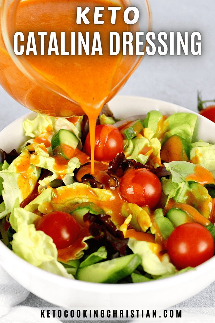 a salad in a white bowl with dressing being drizzled over it and the words keto catalina dressing