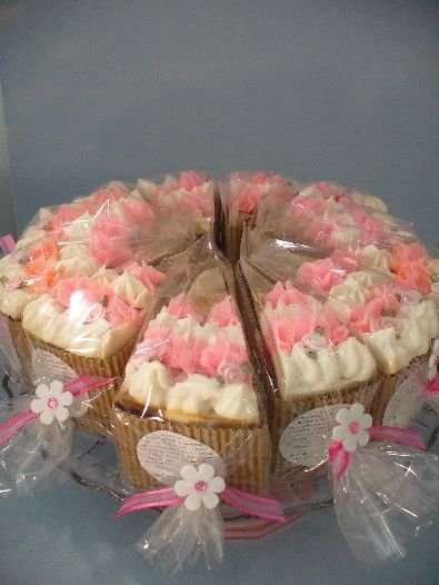 two cakes with pink and white frosting on top