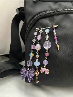 a purse with some charms attached to it