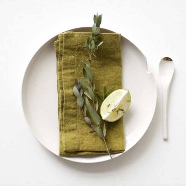 a white plate topped with an apple next to a knife and fork on top of a table