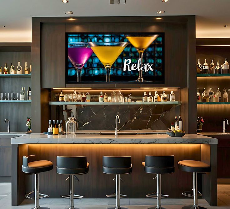 a bar with three stools in front of it and a television on the wall