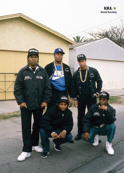 the gang is posing for a photo on the street