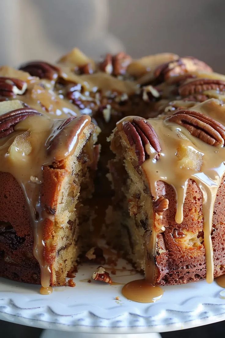 a bundt cake with pecans and caramel drizzle on top