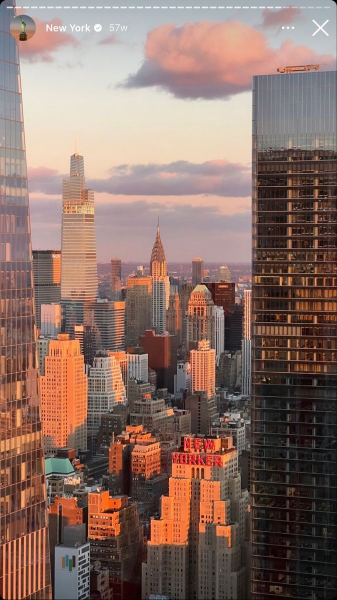 an aerial view of the city at sunset with skyscrapers in the foreground and clouds in the background