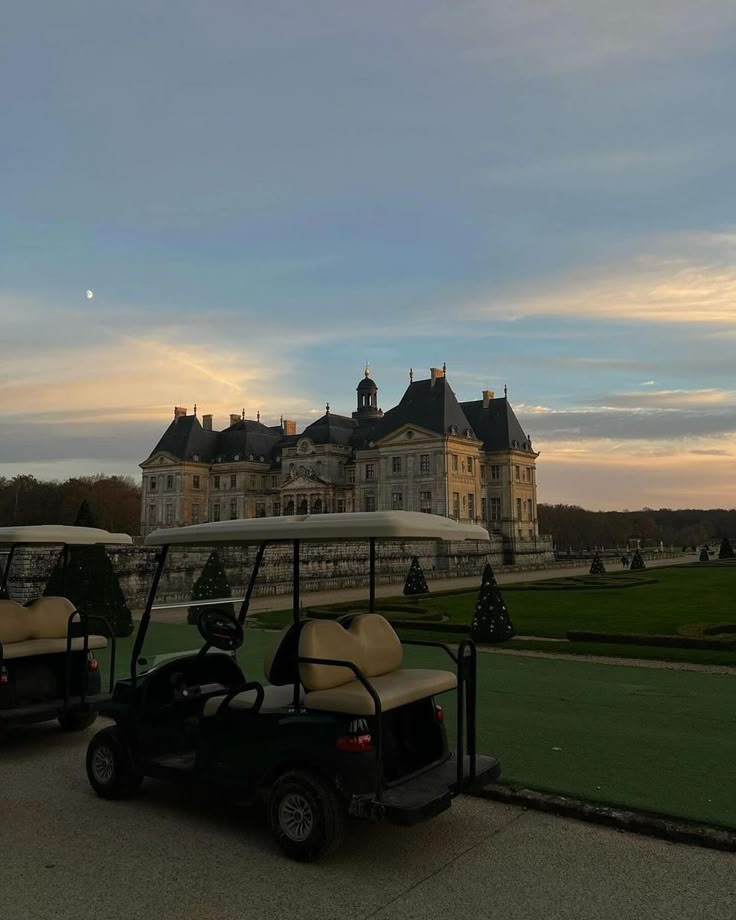 two golf carts parked in front of a large building