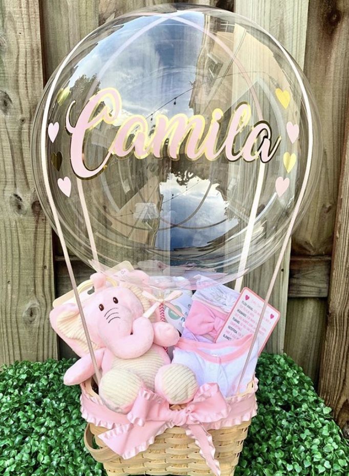 a pink teddy bear in a basket with the word'pamia'on it