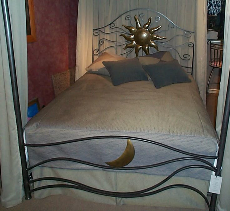 a bed with white canopy and blue pillows