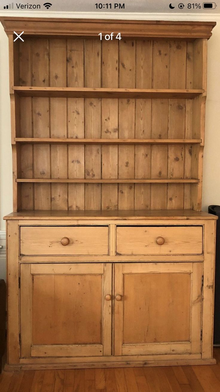 an old wooden bookcase with two doors and drawers on the bottom shelf is shown