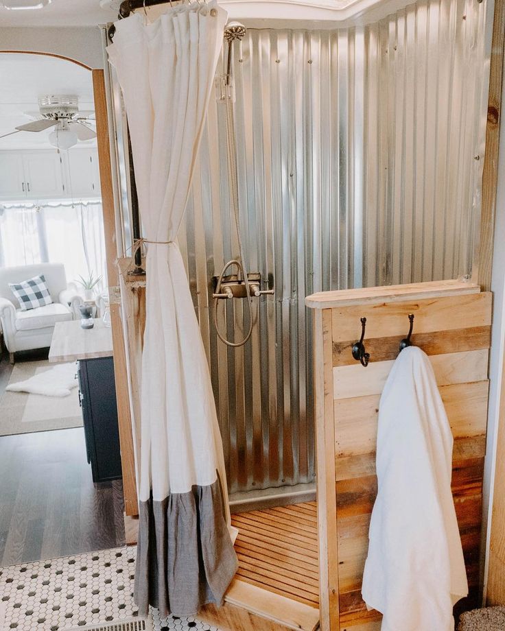 an instagramted photo of a bathroom with the shower curtain pulled back