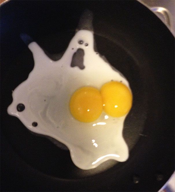 two fried eggs in a frying pan on the stove