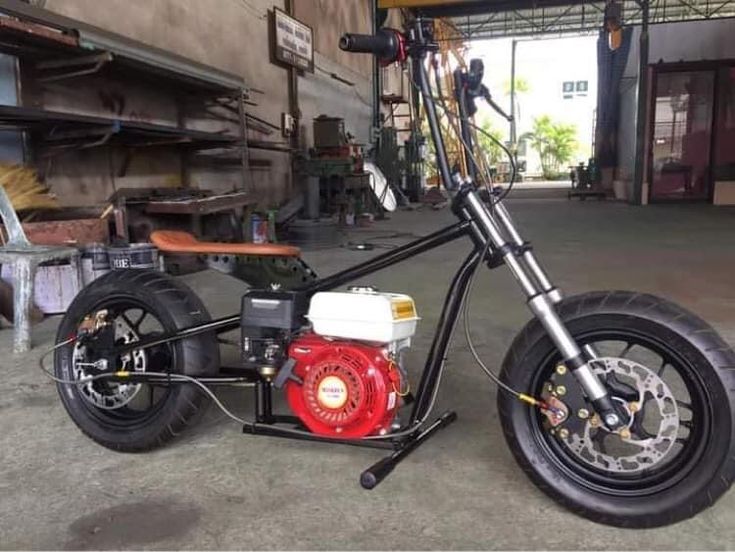 a small motorcycle parked inside of a garage