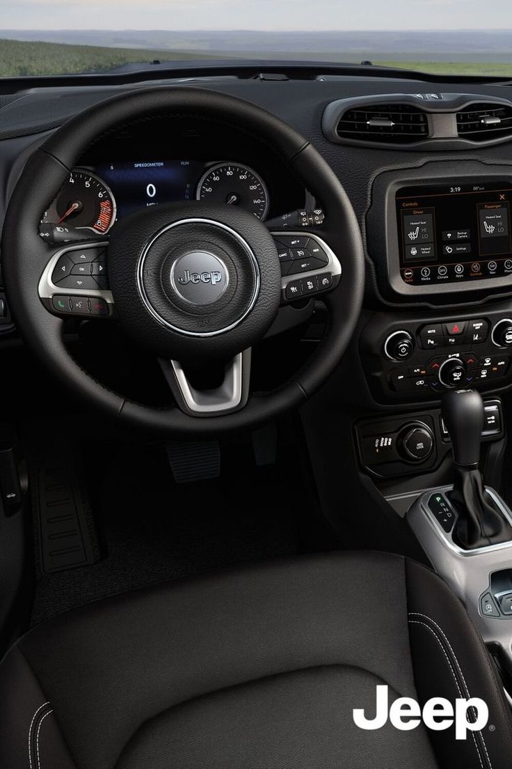 the interior of a jeep is shown with black leather seats and steering wheel, along with dashboard controls