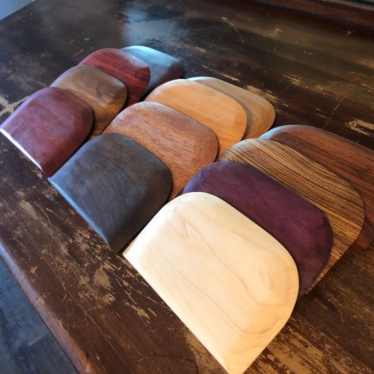 six wooden pieces of wood sitting on top of a table