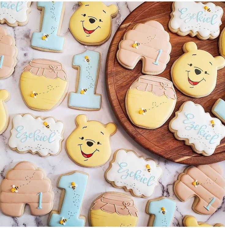 winnie the pooh cookies are arranged on a table