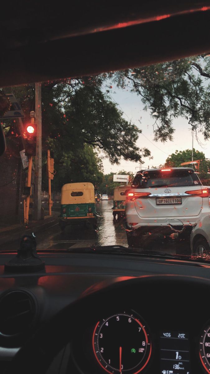 a white car driving down a street next to a traffic light