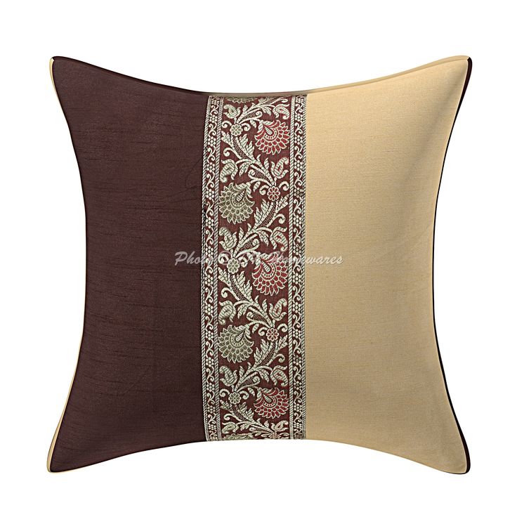 a brown and beige pillow with an embroidered border