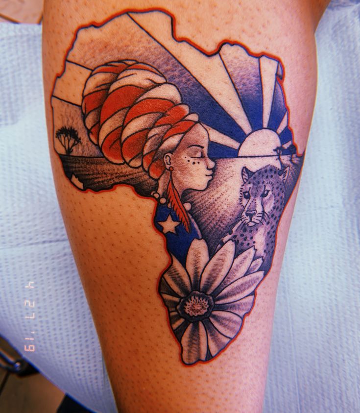 a woman's leg with an american flag and flowers on the side of her thigh