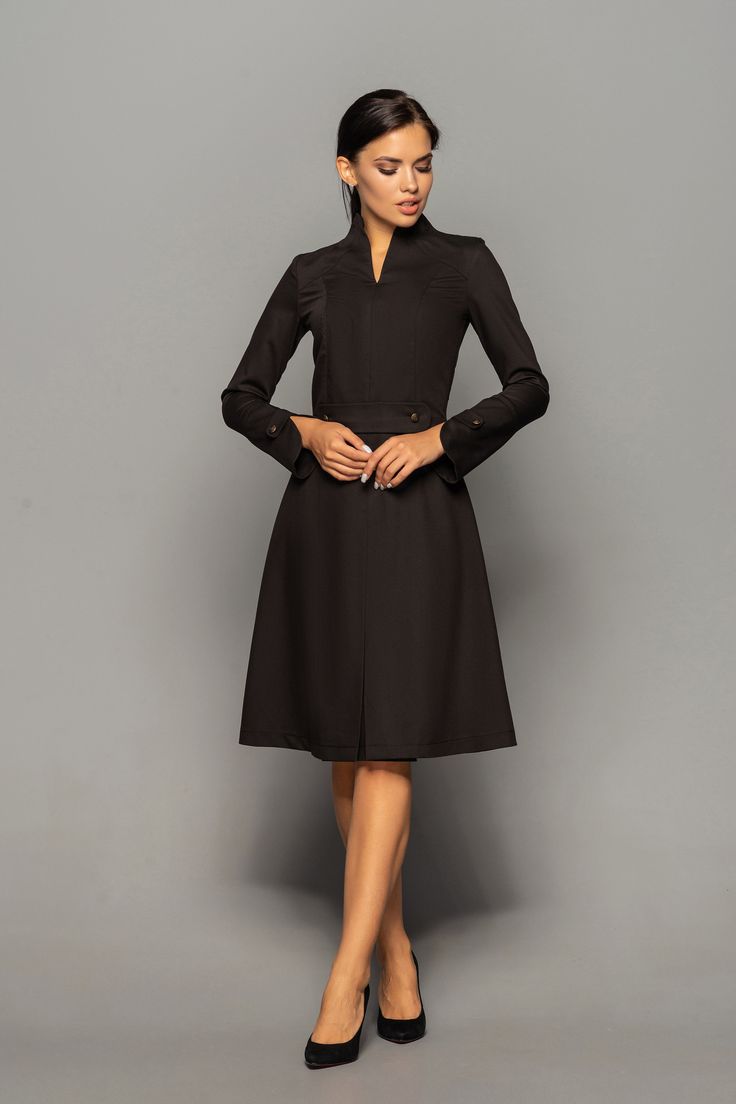 "A beautiful structured dress featuring high neck collar, a-line silhouette, and long sleeves. - high neck (stand collar) - trapeze skirt with inverted front pleat - long sleeves with elegant cuffs - knee length (midi) - a line silhouette - the dress is decorated with high-quality metal buttons Perfect as party, modest bridesmaid or elegant office dress. Seasons: autumn, winter, spring. Color: Black Fiber: viscose - 60%, elastan - 5%, polyester - 35% Concealed back zipper closure For Size S (6 U Cocktail Dress Classy Evening Short, Dresses With Sleeves Elegant, Cocktail Dress Classy Evening, Elegant Purple Dresses, Wedding Guest Dresses With Sleeves, Formal Wedding Guest Dresses, Unique Cocktail Dresses, Elegant Cocktail Dresses, Black Wedding Guest Dresses