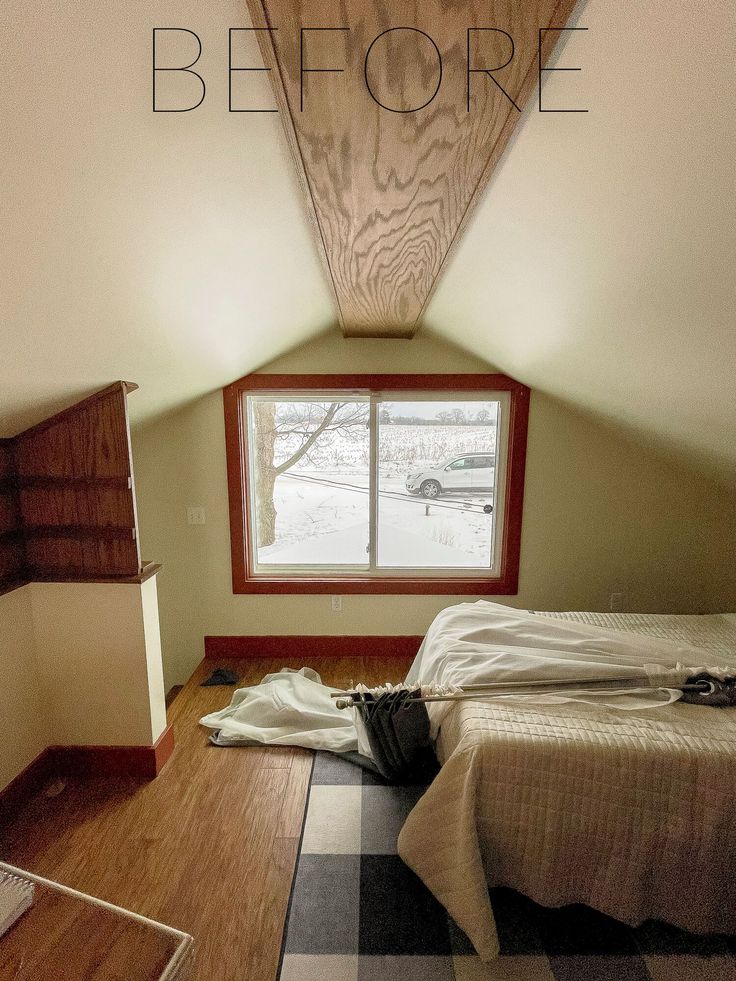 an attic bedroom with wood floors and a window that reads before it has been painted