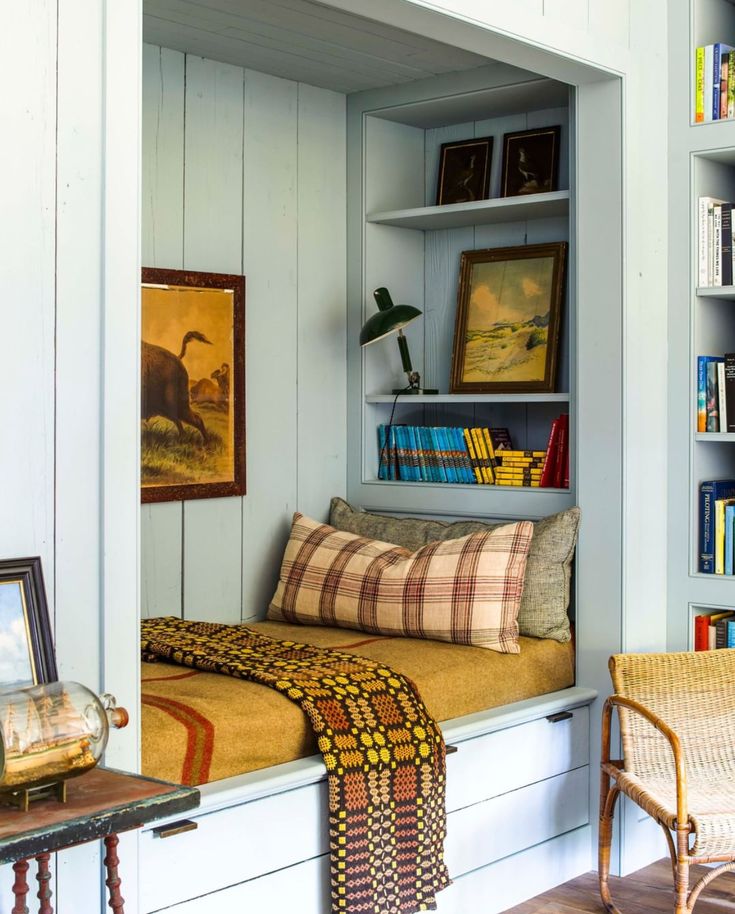 a room with some bookshelves and pictures on the wall