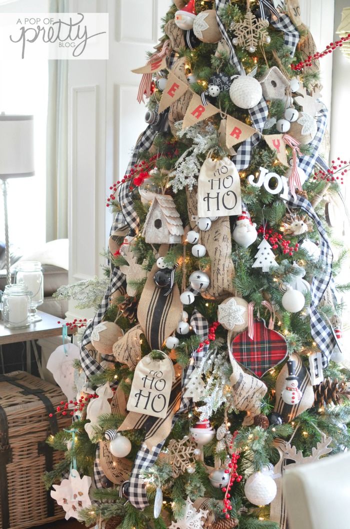 a christmas tree decorated with burlocks, plaid ribbon and other holiday decor items