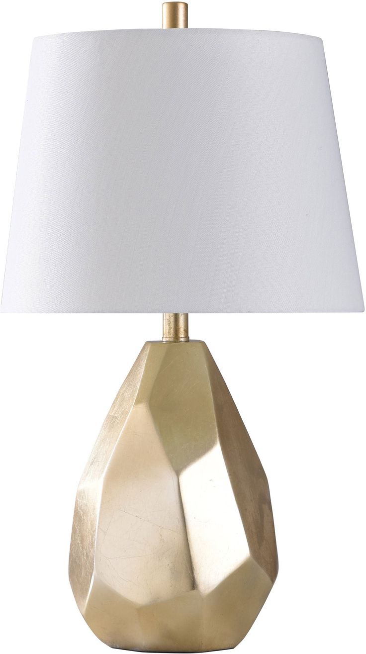 a gold table lamp with a white shade