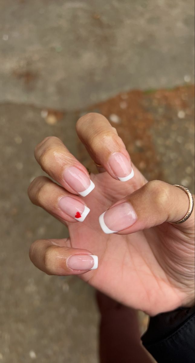 French Manicure with heart Spring 2022 Square French Tip With Design, French With Hearts, Heart On French Tip Nails, French Nails With Small Design, Square Nails With Hearts, Short Acrylic Nails Heart, Simple Nails Heart, French And Heart Nails, French Tip With Love Heart