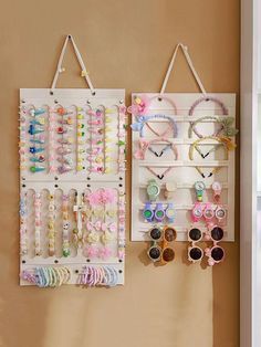 the wall is filled with different types of bracelets and earring holders hanging on hooks