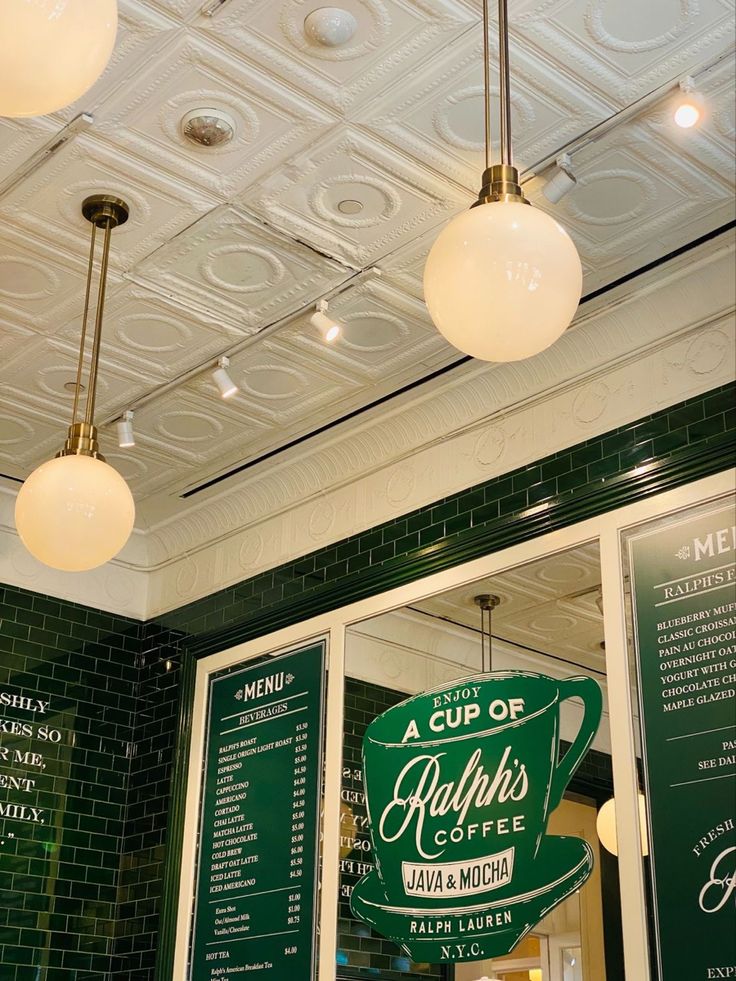 the inside of a coffee shop with menus and lights