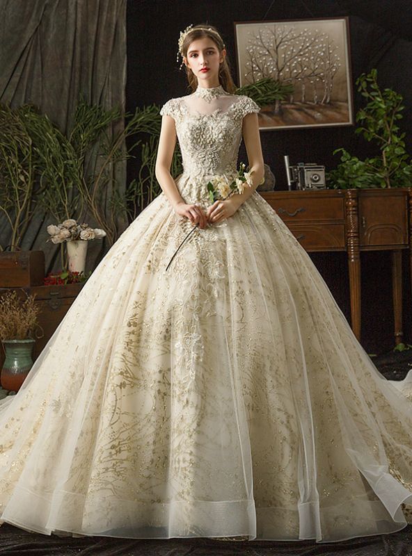 a woman in a wedding dress standing on a bed