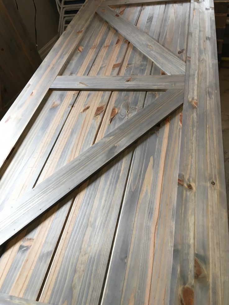 a close up of a wooden door on top of a table with wood planks