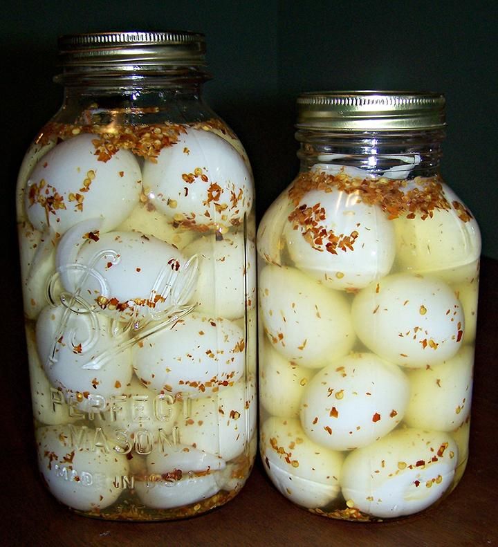 two mason jars filled with hard boiled eggs