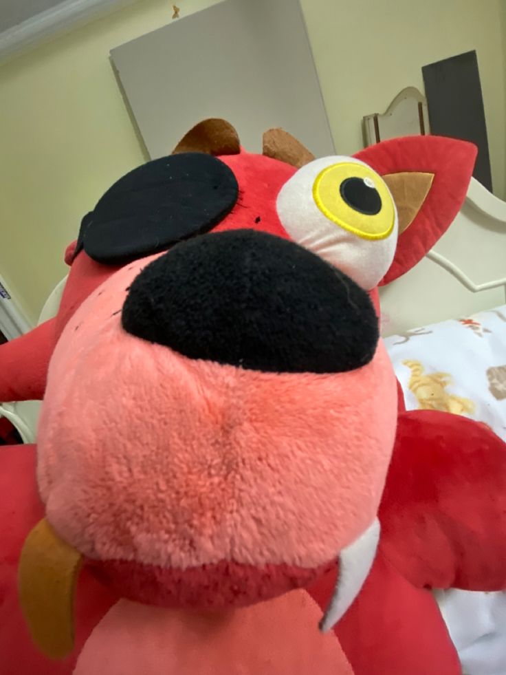 a red stuffed animal with the word fox on it