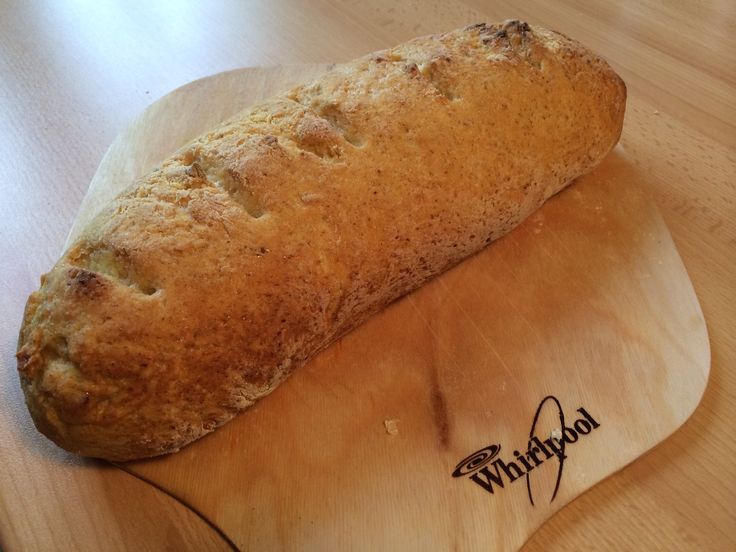 a loaf of bread sitting on top of a wooden cutting board