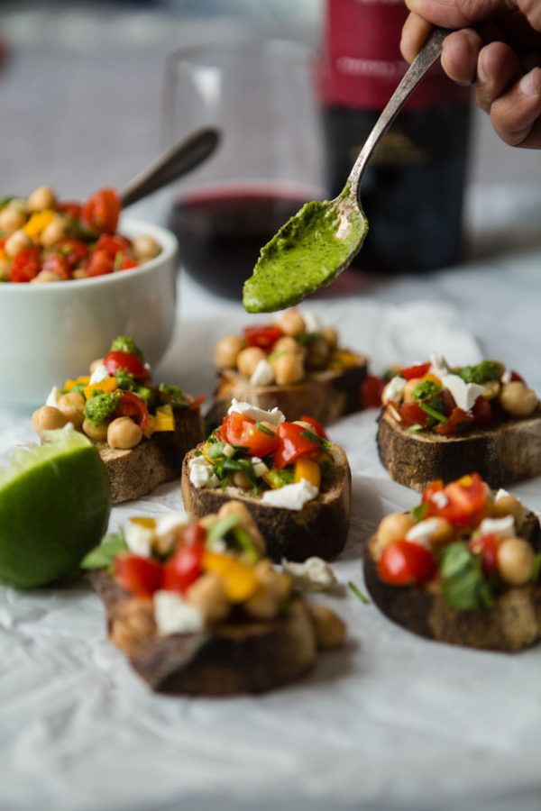 a person is spooning some food out of small pieces of bread