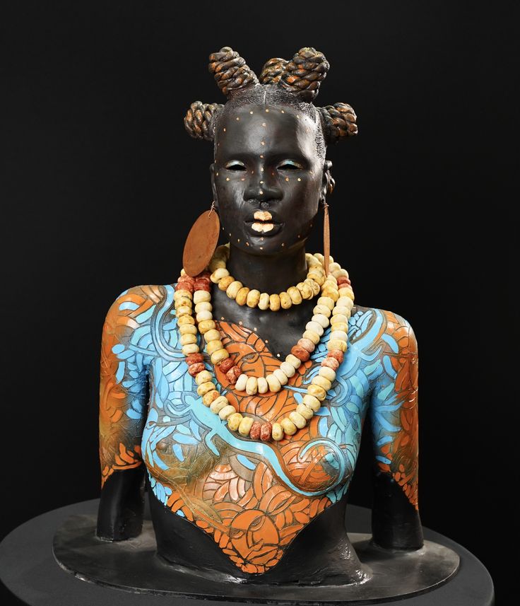 an african woman with beads and necklaces on her head is shown in front of a black background