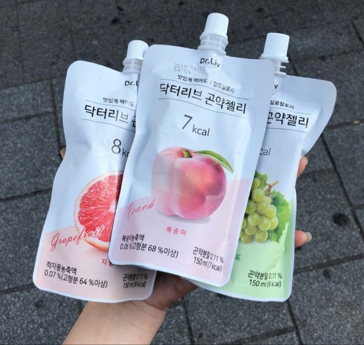 three packets of fruit are held in their hands