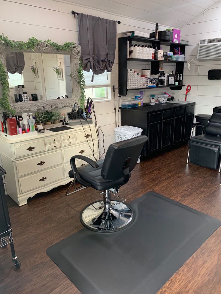 a hair salon with chairs, mirrors and other items on the counter top in front of it