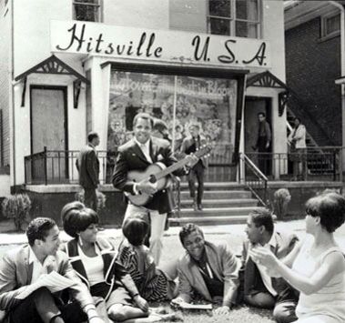 an old black and white photo of people playing guitar